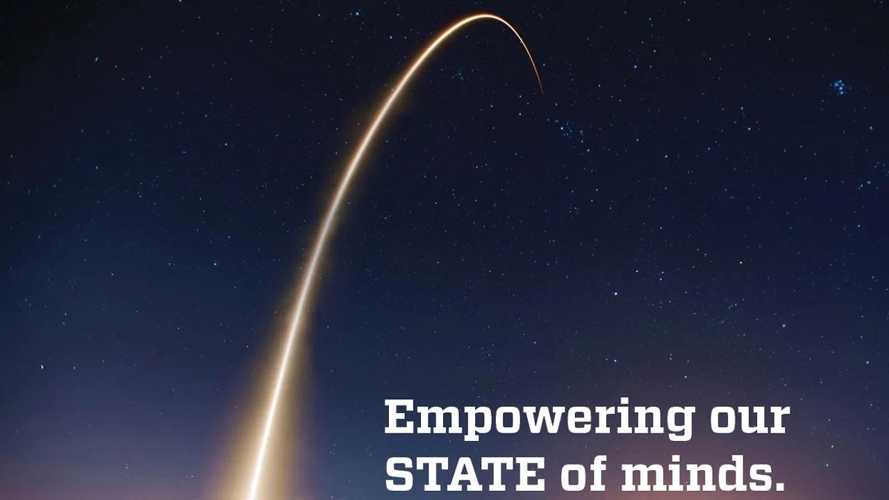 An arc of light, like a comet, in the sky. Text reads "Empowering our state of minds."