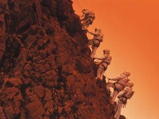 Graphic of astronauts climbing up a rocky mountainside.